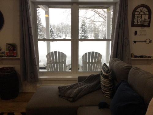a living room with a couch and a window at Our Place Up North BnB in Huntsville