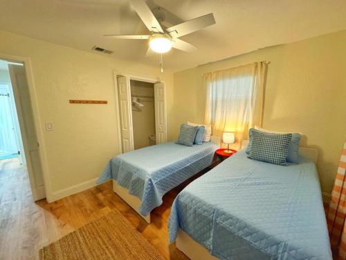 a bedroom with two beds and a ceiling fan at *NEW* Gorgeous Sunshine - 2BD/1BA - Private Fenced Backyard! in Port Orange