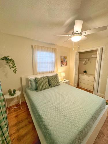 a bedroom with a large bed with a ceiling fan at *NEW* Gorgeous Sunshine - 2BD/1BA - Private Fenced Backyard! in Port Orange