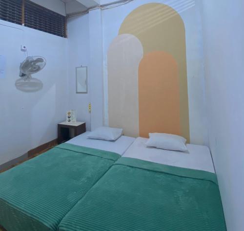 A bed or beds in a room at Anda Hostel By Lorent Room