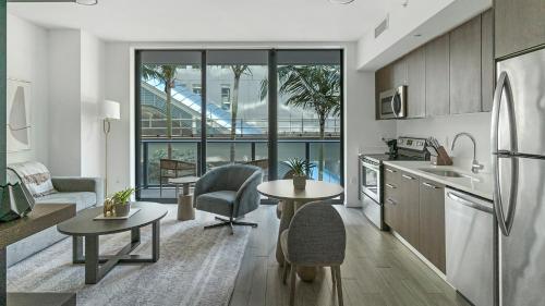 a kitchen and living room with a table and chairs at The Bayfront in Miami