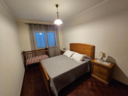 a small bedroom with a bed and a window at SAO PEDRO APARTMENT in Santa Cruz