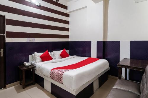 60800 Hotel Landlord في Rohtak: غرفة نوم بسرير مع جدار مخطط