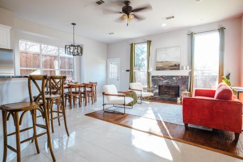 a living room with a red couch and a fireplace at Elegant Executive Escape 3800 sqft 5 bedroom home in Dallas