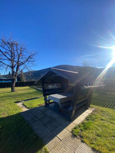 a picnic table with the sun in a yard at Apartma Ella in Lovrenc na Pohorju