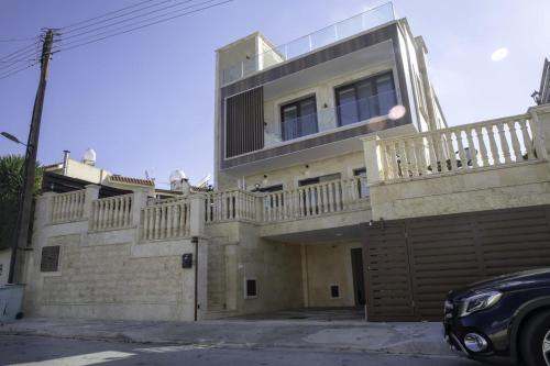 a house with a balcony on top of it at Luxury 5BR Private Villa with Pool - Paphos in Khlorakas