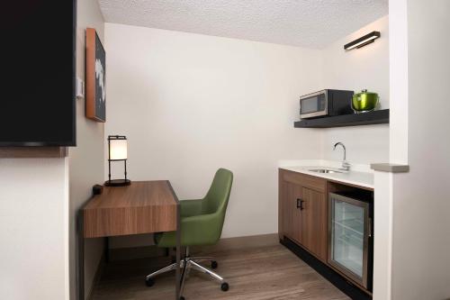 a kitchen with a desk and a chair and a sink at Hyatt Place Denver Tech Center in Centennial