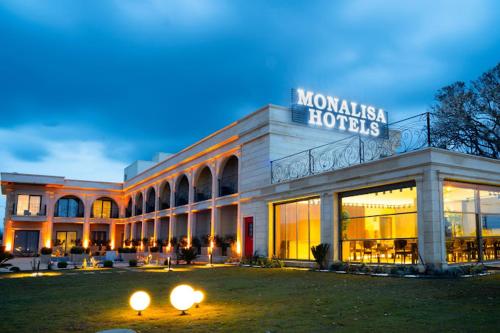 a building with a sign on the front of it at MONALİSA HOTELS ÇANAKKALE in Hamidiye