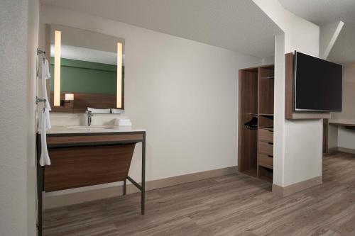 a bathroom with a sink and a large mirror at Hyatt Place Denver Tech Center in Centennial