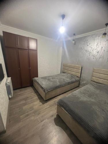 a bedroom with two beds and a cabinet at Miasnikyan Guest House in Yerevan