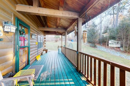 a porch of a cabin with a bench on it at Lake Bomoseen Log Cabin in Bomoseen