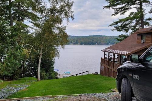 a house with a view of a lake at Lake Bomoseen Log Cabin in Bomoseen