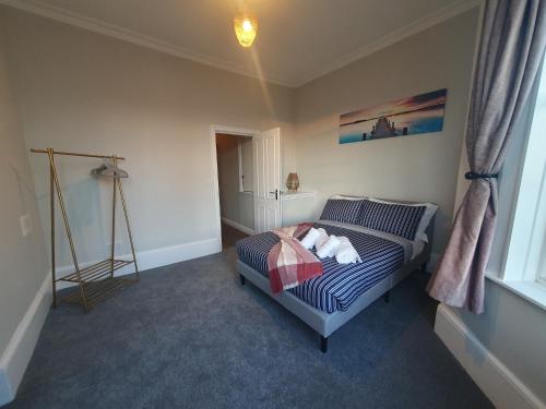 a bedroom with a bed and a window at Clarence House in Brighton & Hove