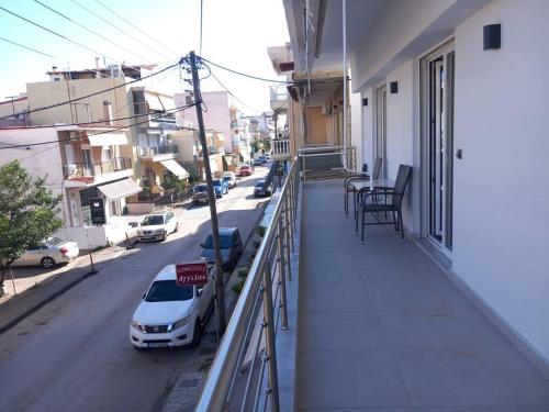 a balcony with a car parked on a street at Marika's Place in Néa Péramos
