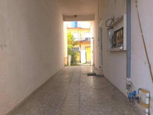 an empty hallway of a building with a tv on the wall at Marika's Place in Néa Péramos