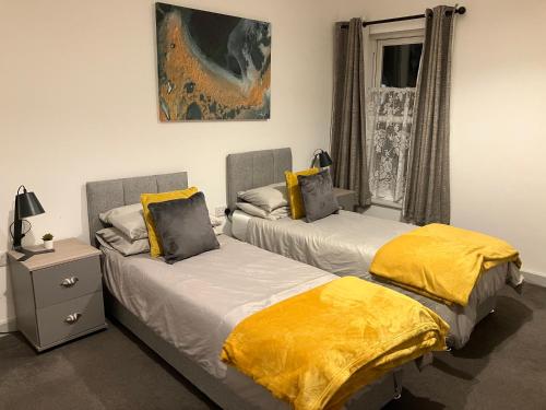 two beds sitting next to each other in a room at Lancing Apartments 2 Bedrooms, Sleeps 5 to 6 First floor Slough M4 Legoland in Slough