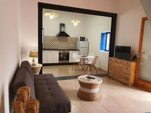 a living room with a couch and a table at Villa Marta Formentera in Sant Ferran de Ses Roques