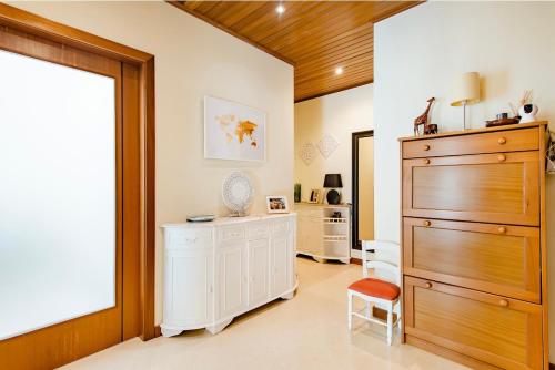 a room with a large chest of drawers and a window at To Be Apartments in Bobadela