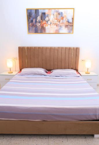 a bedroom with a large bed with two lamps at Appartement Haut standing S+3 - plein centre ville in Tunis