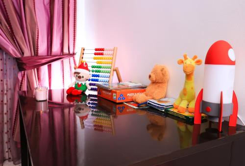 a table with stuffed animals and a toy rocket at Appartement Haut standing S+3 - plein centre ville in Tunis