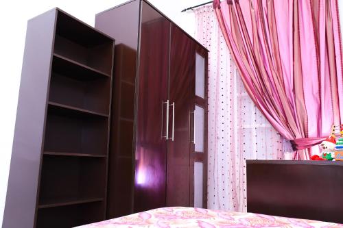 a bedroom with a bed and a wooden book shelf at Appartement Haut standing S+3 - plein centre ville in Tunis