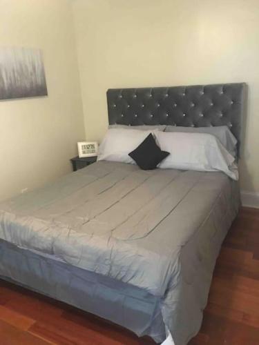 a bedroom with a large bed with a black headboard at The luxury lounge in Schenectady