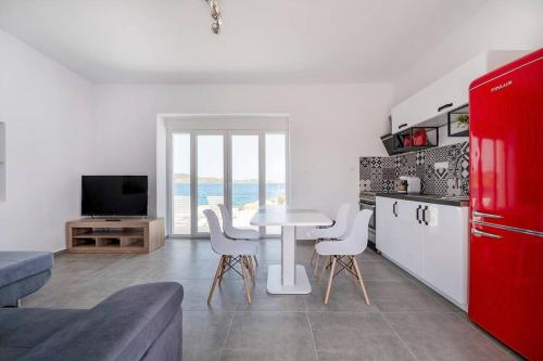 a kitchen with a table and chairs in a room at Poseidon House in Pollonia