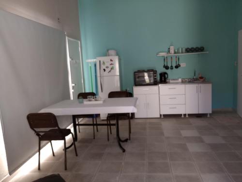 a kitchen with a table and chairs and a refrigerator at MUY LUMINOSO in Lomas de Zamora