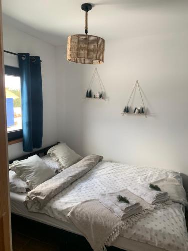 a bed in a bedroom with two shelves on the wall at sKLONowane domki pod Czarną Górą in Bystrzyca Kłodzka