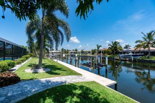 a canal with palm trees and a building at Villa Tranquility-Waterfront-Punta Gorda, FL in Punta Gorda