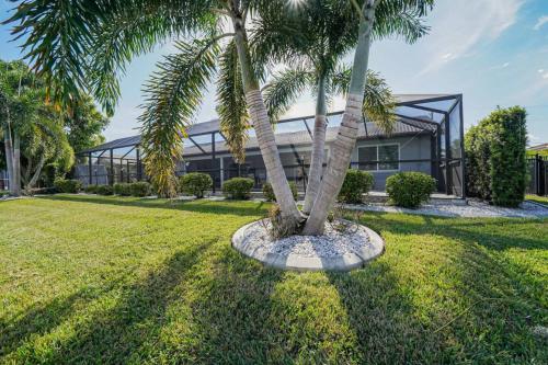 a palm tree in front of a building at Villa Tranquility-Waterfront-Punta Gorda, FL in Punta Gorda