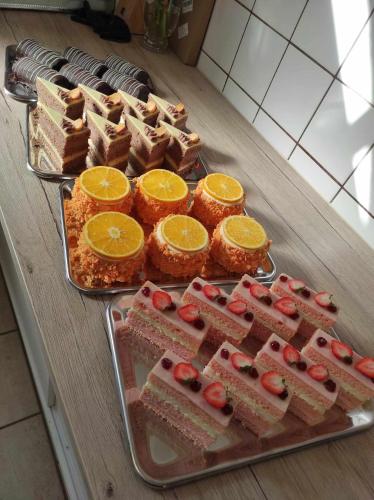 a table with several different types of cakes and orange slices at Scharfer Kessel in Weimar