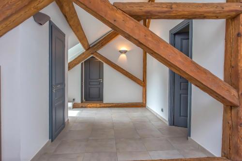 an attic hallway with wooden beams and doors at Domaine au cœur des 3 vallées in Moutiers