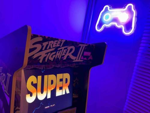 a box of cereal and a sign that says street fighter iv at Essex 2-Bed House nr Stanstead with Arcade Machine in Braintree
