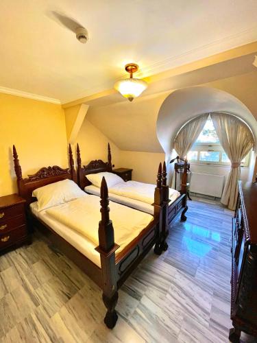 a bedroom with two beds and a arched ceiling at Palace Inn in Jíloviště