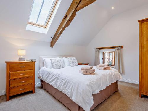 a bedroom with a bed and a dresser and a window at 4 Bed in Taunton KIBTR in Trull