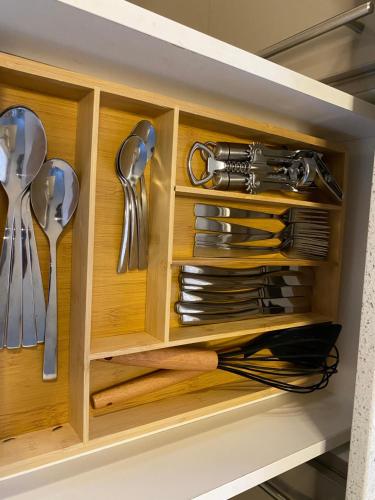 a wooden cabinet with utensils in a kitchen at Stunning gem by OR Tambo Airport in Benoni