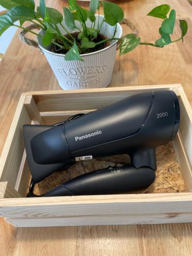 a black hair dryer in a wooden box at Melaka Relax Home - 6 pax - SeaView corner unit - 6 min to Historical Spot & Jonker in Melaka
