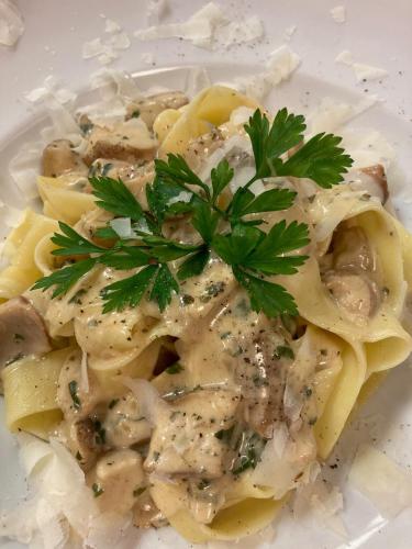 a plate of pasta with parsley on top of it at Hotel Metzgerwirt in Kirchberg in Tirol