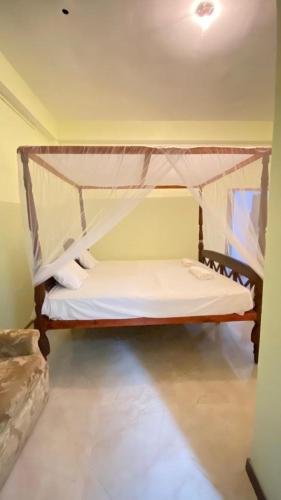 a bedroom with a bunk bed with a canopy at Villa Dilinga in Galle