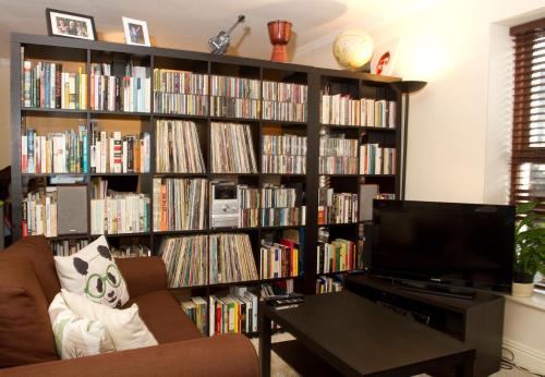 a living room with a book shelf filled with books at Kieran's Place in Dublin