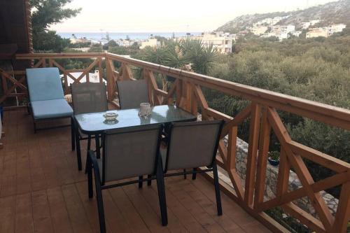 a table and chairs on a balcony with a view at Beautiful Villa with a private pool ! in Heraklion