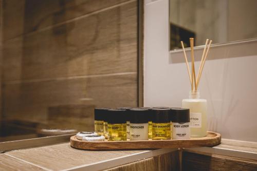 a tray with four bottles of essential oils on a counter at Naias Nemeia Luxury Rooms in Neméa