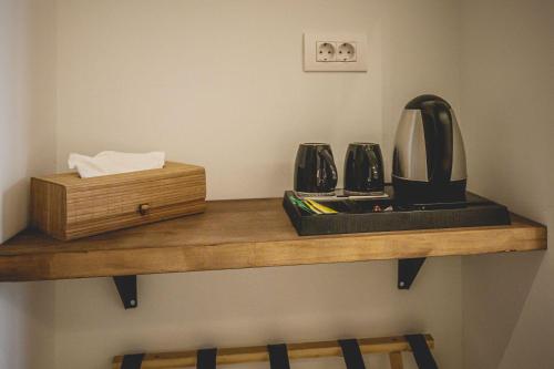 a shelf with a coffee maker and a box on it at Naias Nemeia Luxury Rooms in Neméa