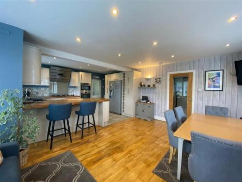 a kitchen and living room with a table and chairs at Brixham View House in Torquay