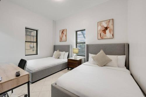 a hotel room with two beds and a couch at Modern Luxe in Bay Ridge Your Brooklyn Hideaway in Brooklyn