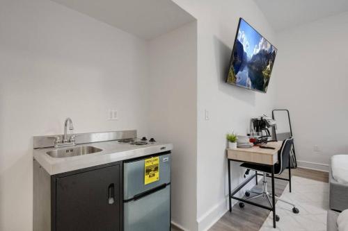a kitchen with a sink and a desk in a room at Modern Luxe in Bay Ridge Your Brooklyn Hideaway in Brooklyn
