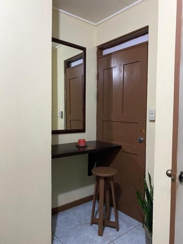 a bathroom with a vanity and a mirror and a stool at Gamboa Lodging 1 in Liberia