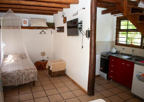 a kitchen with a bed and a sink in a room at Bosque & Mar in Mar del Plata