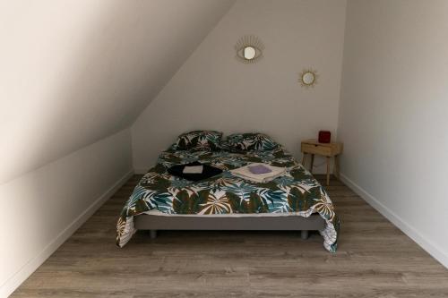 a bedroom with a bed in a attic at La Roseraie des Princes in Montbéliard